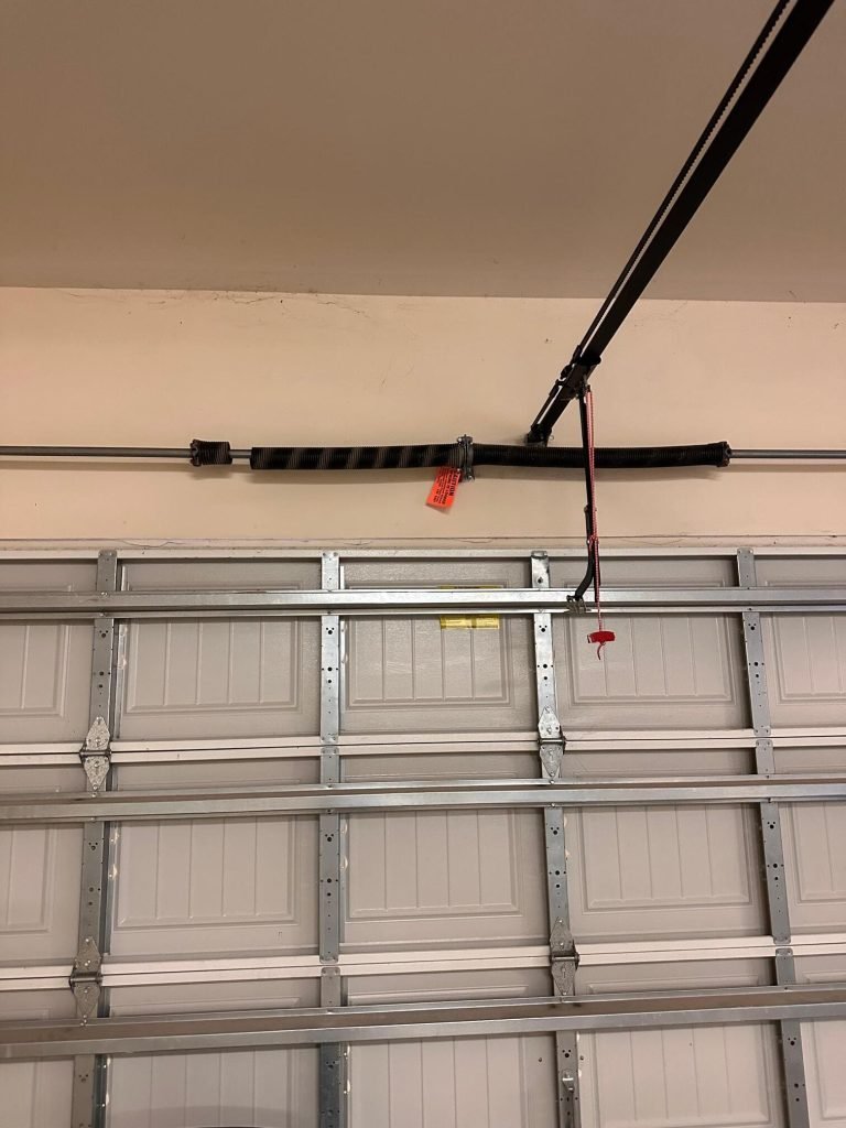 Inside a sectional garage door: top section, hinges, struts and the opener arm on the top bracket