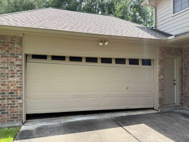 Cream short-panel steel garage door with a row of windows in the top section